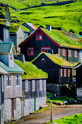 Traditional village with colorful houses and grass on the roofs. Mykines island, Faroe Islands