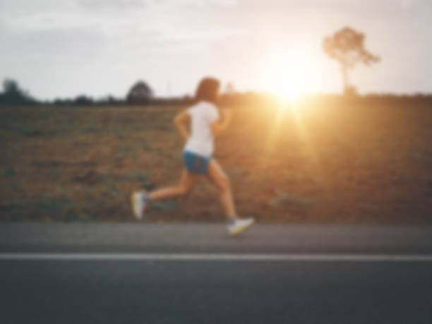 istock Asian woman running on paved road 1595390020