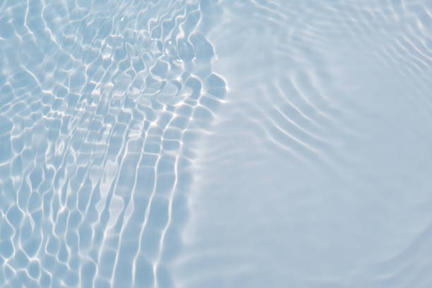 istock Blue water with ripples on the surface. Defocus blurred transparent blue colored clear calm water surface texture with splashes and bubbles. Water waves with shining pattern texture background. 1595460126