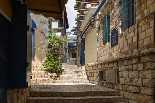 Safed, Israel, July 01, 2023 : A stone staircase leading up connects two quiet streets with stone houses in the old part of Safed city in northern Israel