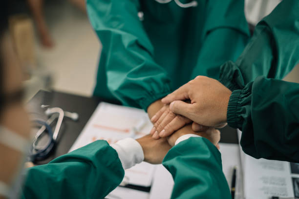 istock Doctors shaking hands, working together as a team at the hospital. 1595506654