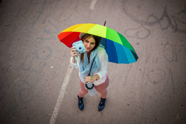 Young girl taking photos outdoors