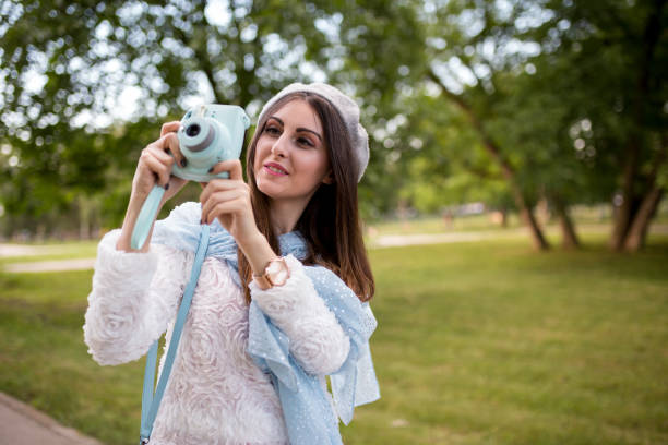 Young girl taking photos outdoors