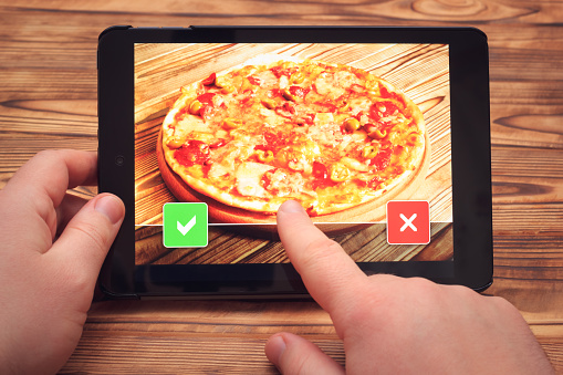Online pizza ordering. Tablet screen with apply or decline buttons.