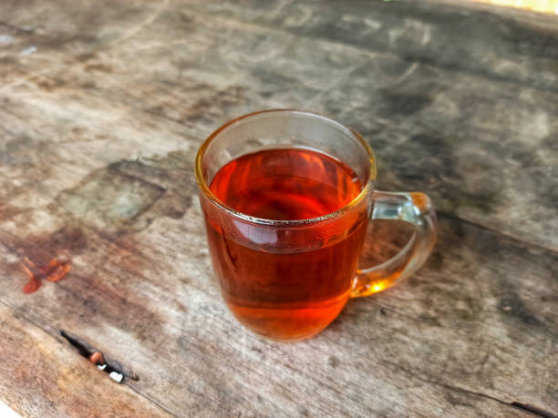 istock Sip of Comfort: Warm Tea in a Glass on Wooden Table 1595577654