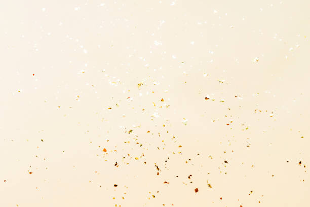 istock Shiny golden confetti on beige background, texture. Holidays concept 1595596817