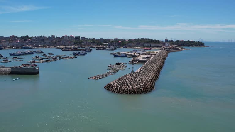 An aerial video of a fishing village and port on a sunny day