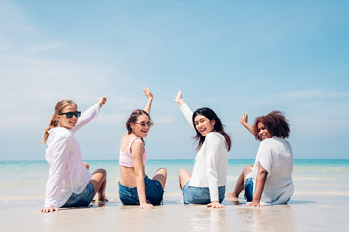 Happy teenagers at beach party together on the beach having fun in a sunny day, Beach summer holiday sea people concept