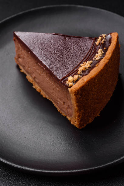 istock Delicious, fresh, sweet chocolate cake with nuts cut into slices 1595611924