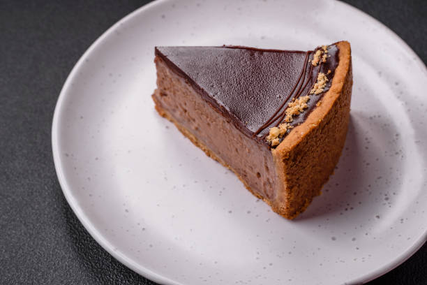 istock Delicious, fresh, sweet chocolate cake with nuts cut into slices 1595611928