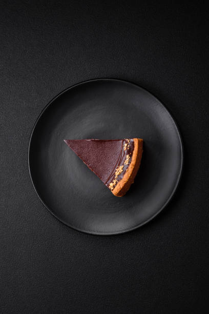 istock Delicious, fresh, sweet chocolate cake with nuts cut into slices 1595612987