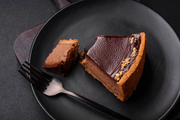 istock Delicious, fresh, sweet chocolate cake with nuts cut into slices 1595615095