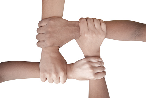 A horizontal cutout of four hands holding each other in handshake. The image denotes the concept of unity, fervour, zeal, confidence, friendship, love care, help, support, strength and determination.There is no text and Copy space for text.