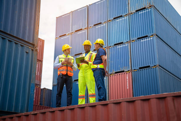 istock Male Industrial Engineer and Foreman control checking container at container yard warehouse. Logistics business. 1595638649