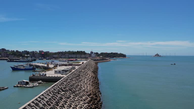 An aerial video of a fishing village and port on a sunny day