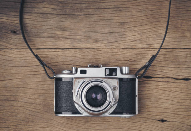 istock vintage old film camera on wood board 1595647538