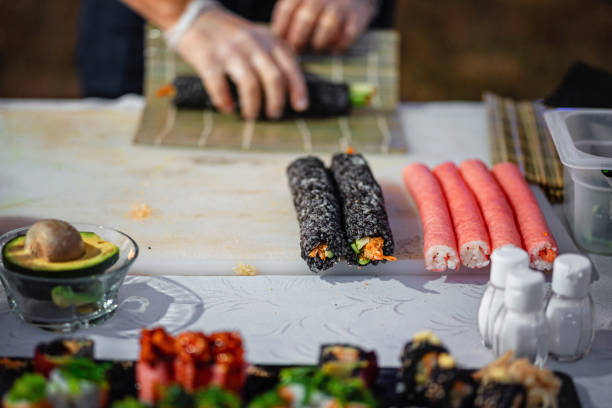 istock Sushi chef preparing sushi rolls for social event 1595652877