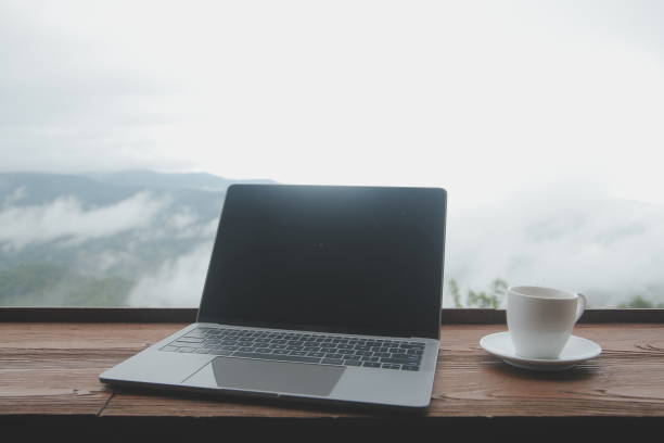 istock Young man freelancer traveler wearing hat anywhere working online using laptop and enjoying mountains view 1595659683