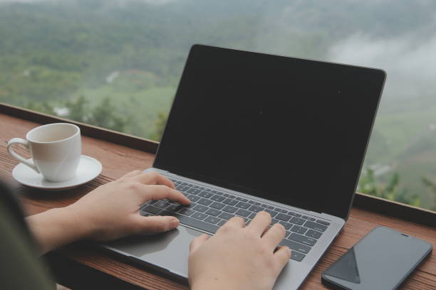 istock Young man freelancer traveler wearing hat anywhere working online using laptop and enjoying mountains view 1595661223