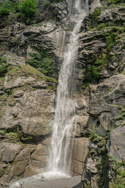 istock Waterfall among rocks and forests on the Alps 1595694858