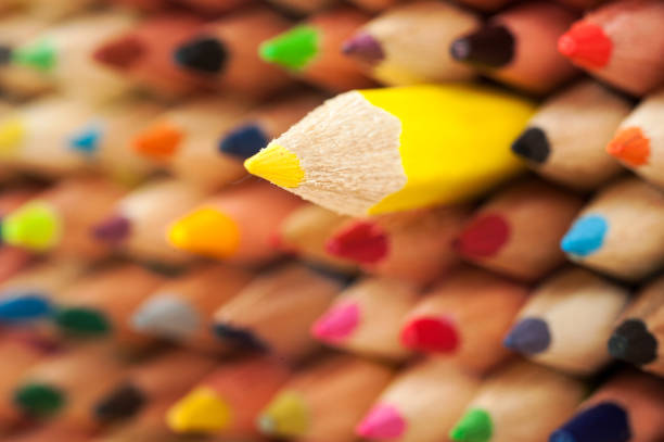 Color image depicting a close up macro abstract view of a collection of colored pencils.