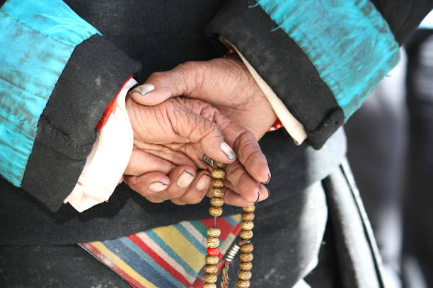 istock Close-up of old hands holding prayer beads 1595721111