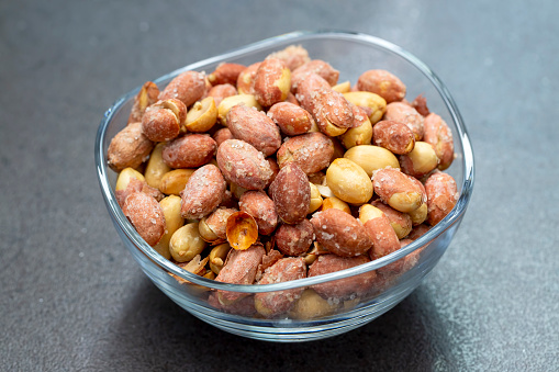 Salted peanuts in a glass bowl