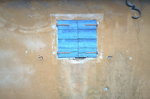 Small window on a weathered wall