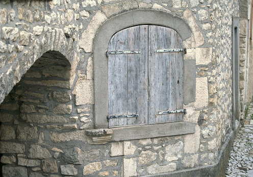 Grey shutters and stone wall