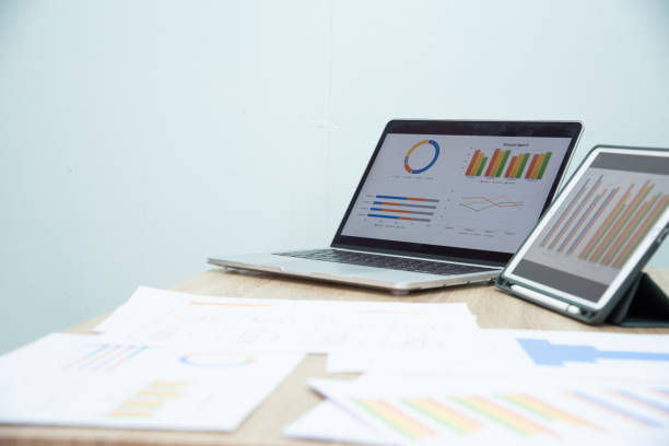 istock Businessman working at office with digital tablet, laptop computer, smart phone. Professional investor connection internet application online. Businessmen review annual company report. 1595812655
