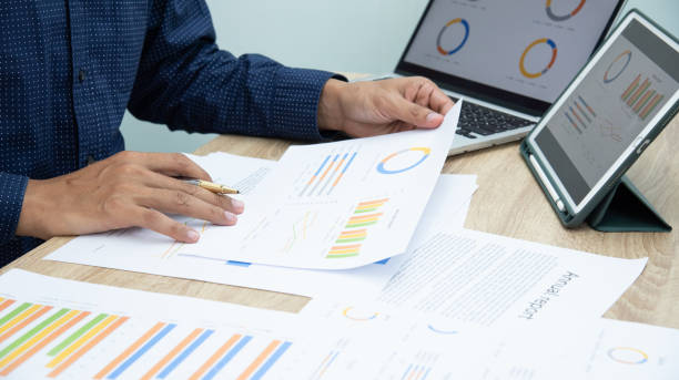 istock Businessman working at office with digital tablet, laptop computer, smart phone. Professional investor connection internet application online. Businessmen review annual company report. 1595812931