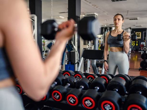 istock Young woman weightlifting at gym 1595828671