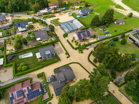 Extreme river flooding from a powerful storm - flooding houses, residential buildings, industrial zones, cars, roads and highways. Water destroying lives and everything in its way. Endless water damage in Slovenia, 2023. Aerial view of floods.