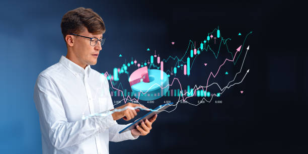 istock Businessman portrait working in tablet, forex diagrams and pie c 1595876713