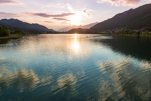 Scenic sunset on the mountain lake. Weissensee lake in Karnten, Austria