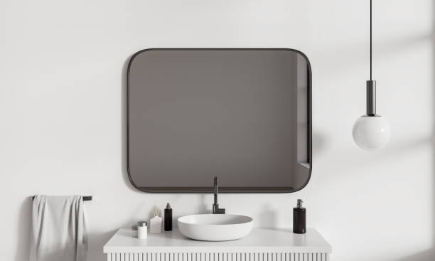 istock White stylish bathroom interior with sink and mirror, accessories on deck 1595903417
