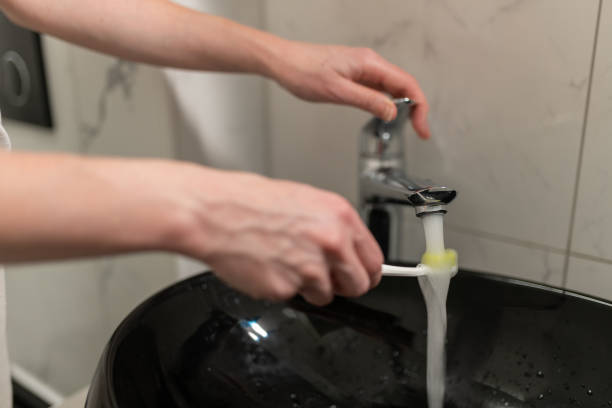 istock A woman is brushing her teeth 1595905548