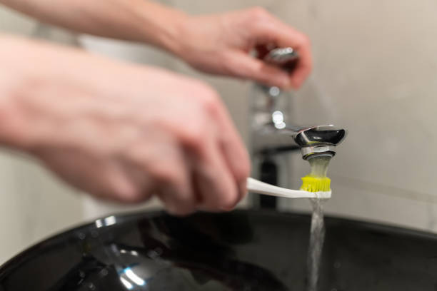 istock A woman is brushing her teeth 1595906642