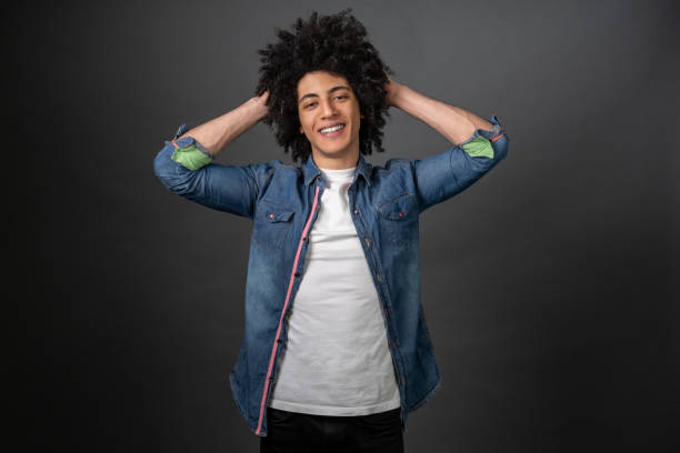 istock Curly-haired young man feeling good and smiling 1595910659