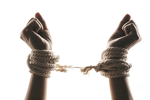 Hands tied up with rope are about to free themselves. Representing freedom speech, freedom of expression issues.