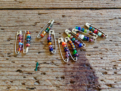 glass beads threaded on safety pin