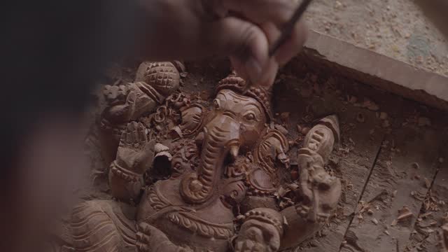 Artisan's Touch:  Carving of Lord Ganesha Wooden Idol