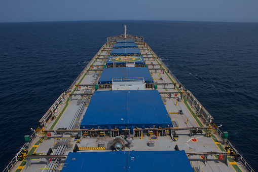Top view of a large cargo ship loading or loading grain. Sea transportation.