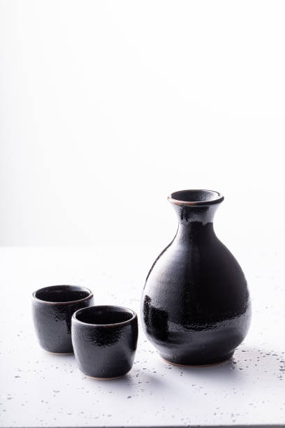 istock Unfiltered Japanese sake in black small ceramics. 1595956644