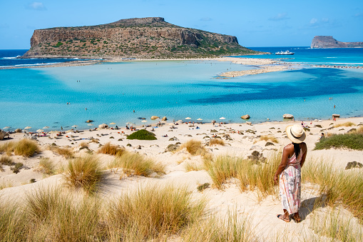 Crete Greece, Balos lagoon on Crete island, Greece. Tourists relax at the crystal clear ocean of Balos Beach. Greece, a Asian woman visit the beach during a vacation in Greece