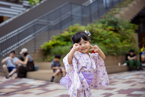 Portrait of little girl in Yukata at summer festival