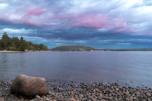 istock Sunset over the lake with a large rock 1595995689