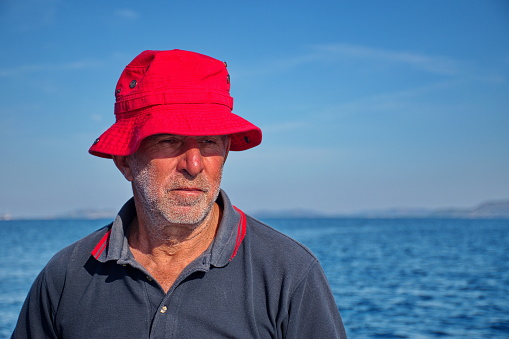 Portrait of senior man against the blue sea and blue sky