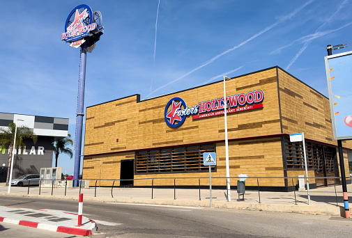 Foster's Hollywood is a chain of American food restaurants in Spain and Portugal. Foster's Hollywood logo sign on Foster's Hollywood on facade restaurant wall. May, 12, 2023, Spain, Sagunto.