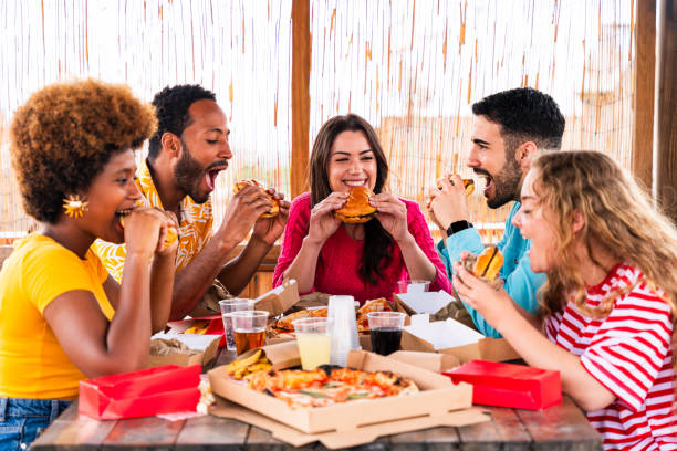 istock Multiethnic group of friends having dinner barbecue party on rooftop at home 1596017749